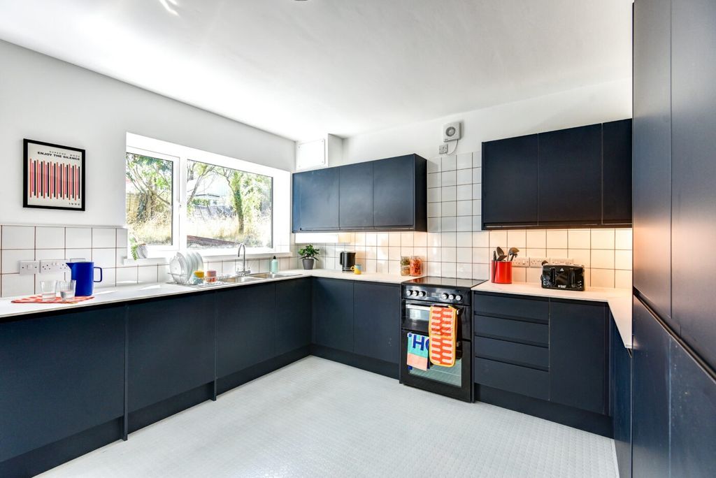 Property photo 2 of 5 Bright, Modern Galley-Style Kitchen With Dark Navy...