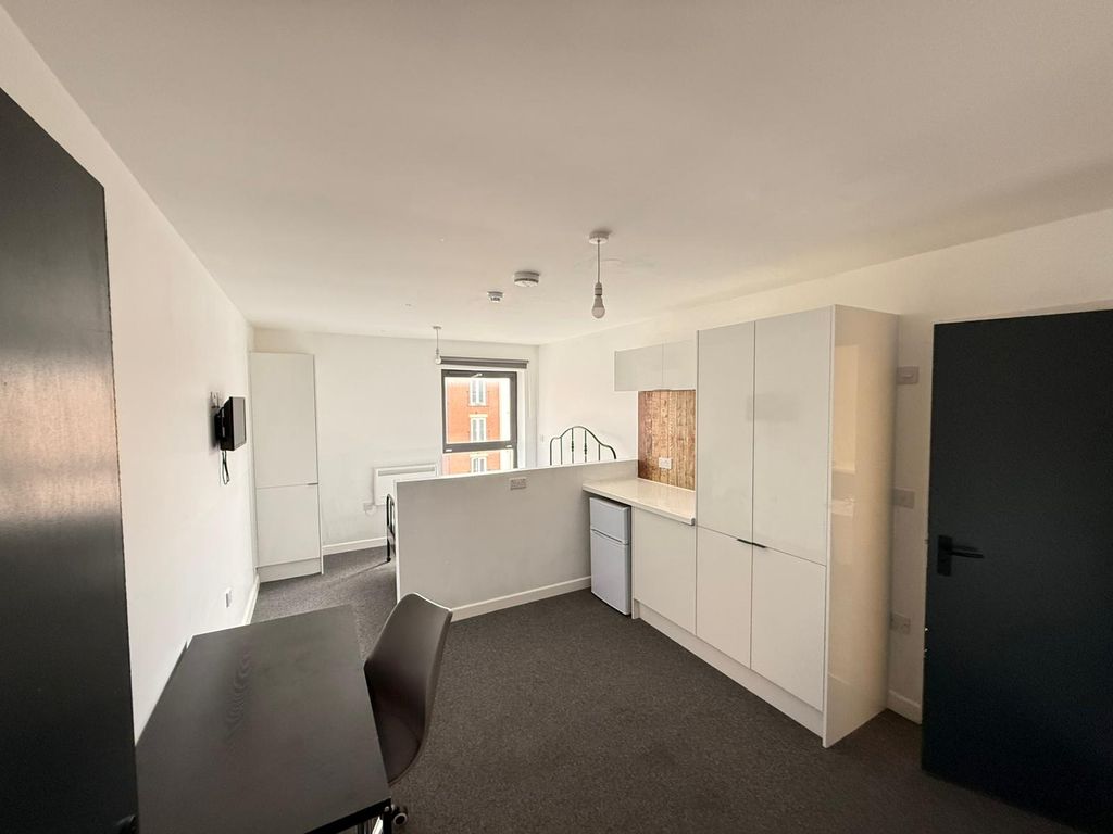 Property photo 1 of 4 Modern Kitchen Area Featuring Sleek Cabinetry And ...