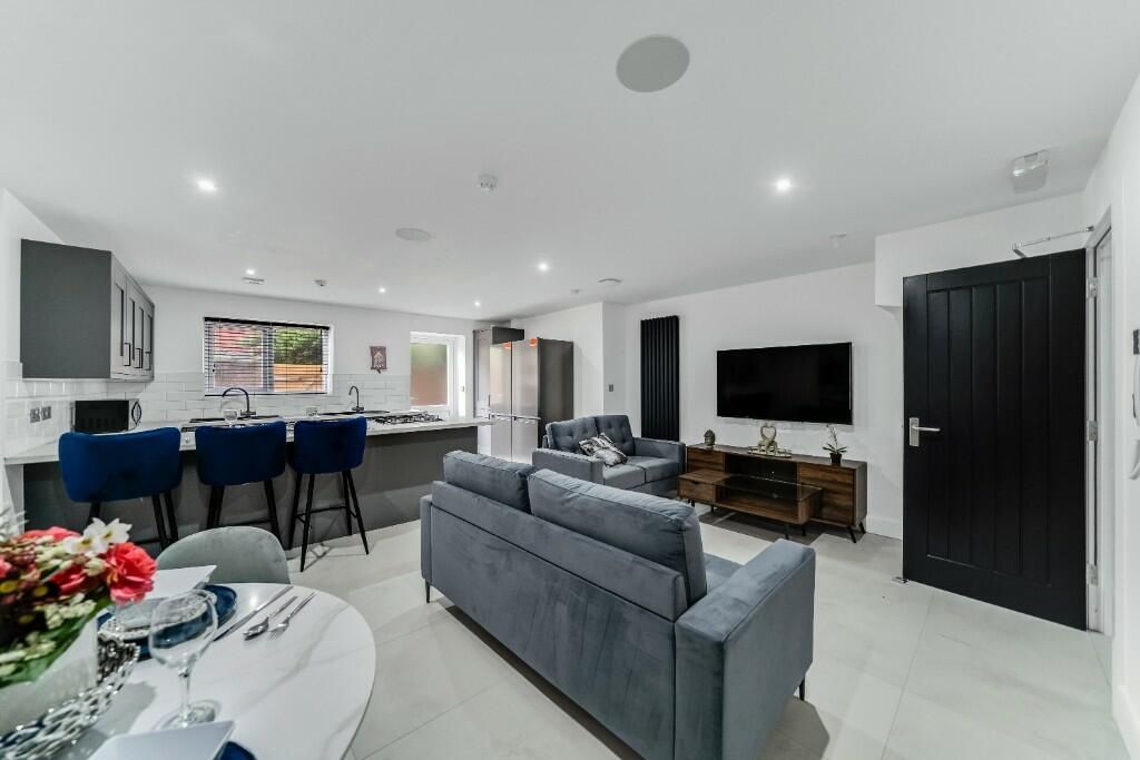 Property photo 2 of 14 A Spacious And Modern Living Room Featuring Ample ...
