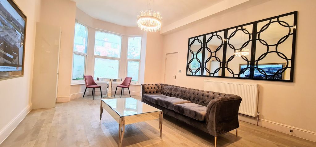 Property photo 1 of 10 Bright And Spacious Living Room Featuring Large Wi...