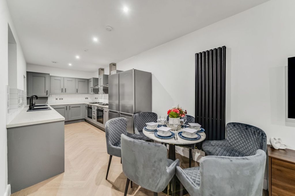 Property photo 2 of 10 A Modern, Stylish Kitchen With Sleek Gray Cabinetr...