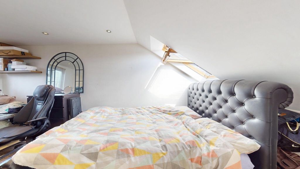 Property photo 1 of 15 A Spacious And Cozy Attic Bedroom With A Large Uph...