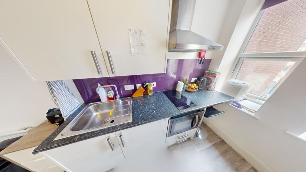 Property photo 3 of 5 Bright And Modern Kitchen Featuring Sleek Cabinetr...