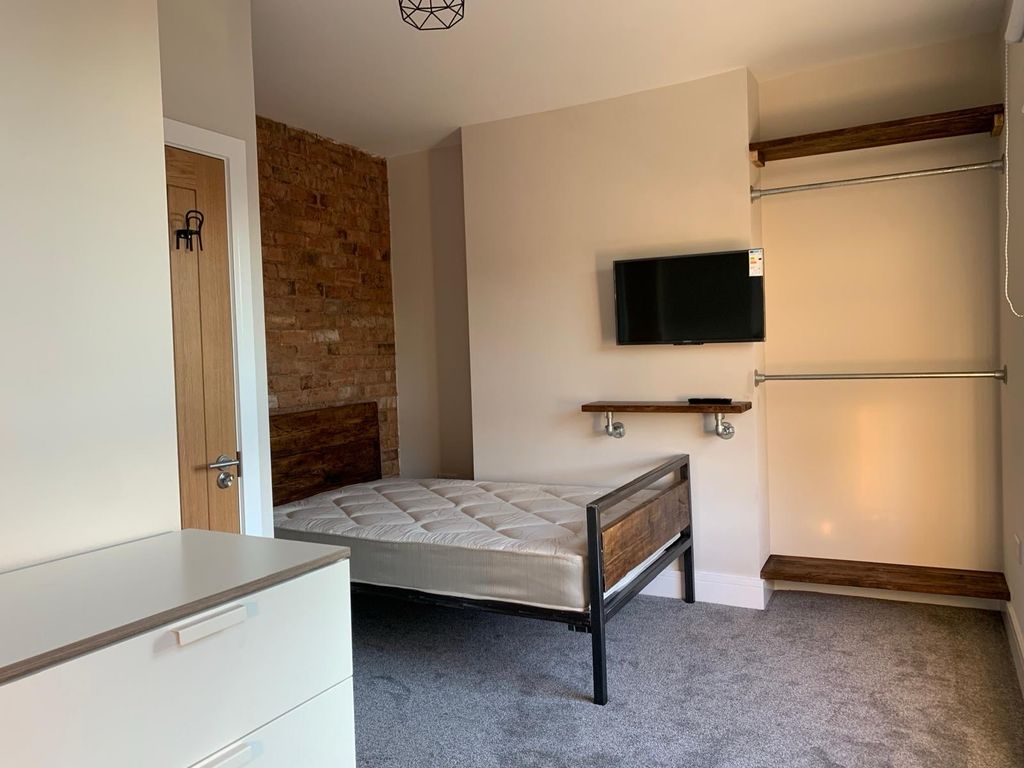 Property photo 2 of 7 A Cozy Bedroom With A Comfortable Bed, A Mounted T...