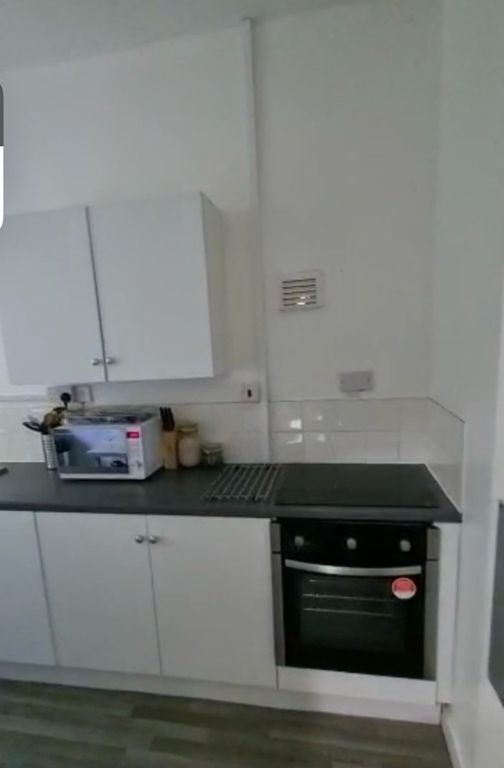 Property photo 3 of 7 A Neat And Functional Kitchen Featuring White Cabi...