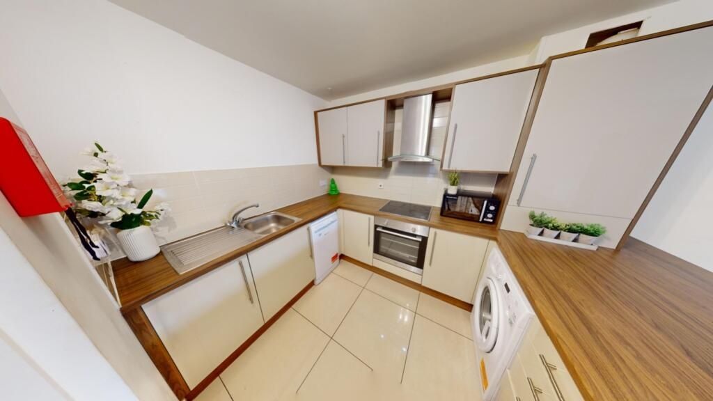 Property photo 3 of 13 A Modern And Clean Kitchen Featuring White Cabinet...