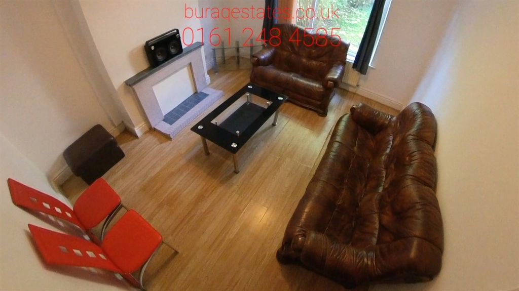 Property photo 1 of 10 A Spacious And Welcoming Living Room Featuring Com...