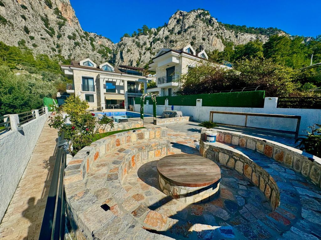 Property photo 2 of 28 A Lovingly-Maintained Smart Home Villa For Sale In Fethiye - Main View Of The Villa, Pool And Feature Seating Area With Fire Pit