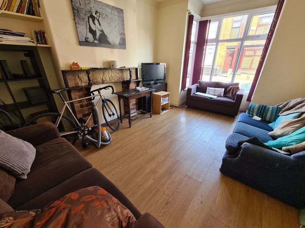 Property photo 1 of 10 Bright And Welcoming Living Room Featuring Large W...