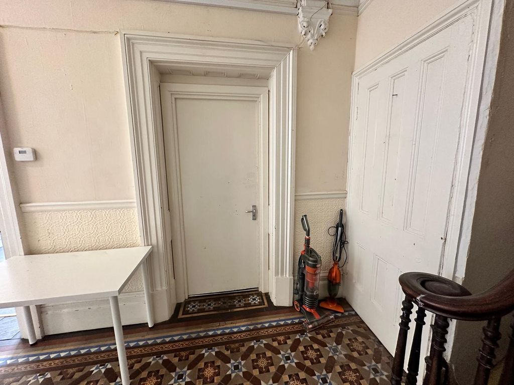 Property photo 3 of 15 A Well-Maintained Hallway Featuring Decorative Flo...