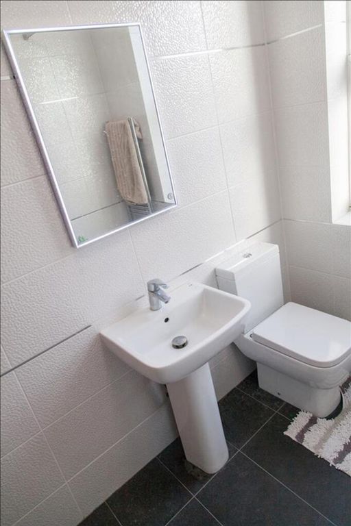 Property photo 1 of 18 Bright And Modern Bathroom Featuring Sleek Fixture...