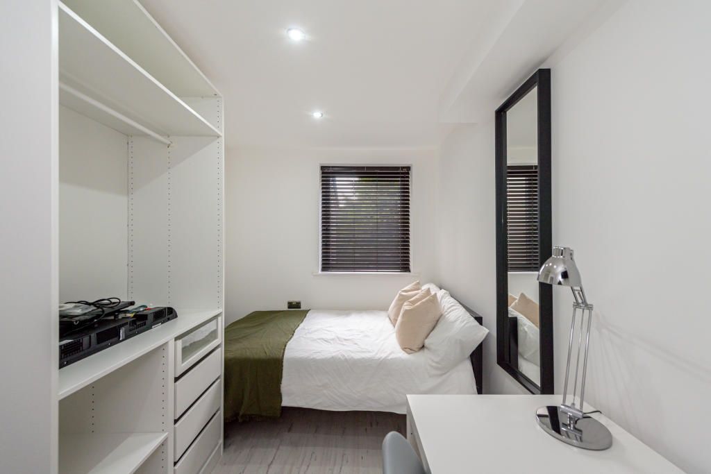 Property photo 1 of 13 A Bright, Modern Bedroom Featuring A Neatly Made B...