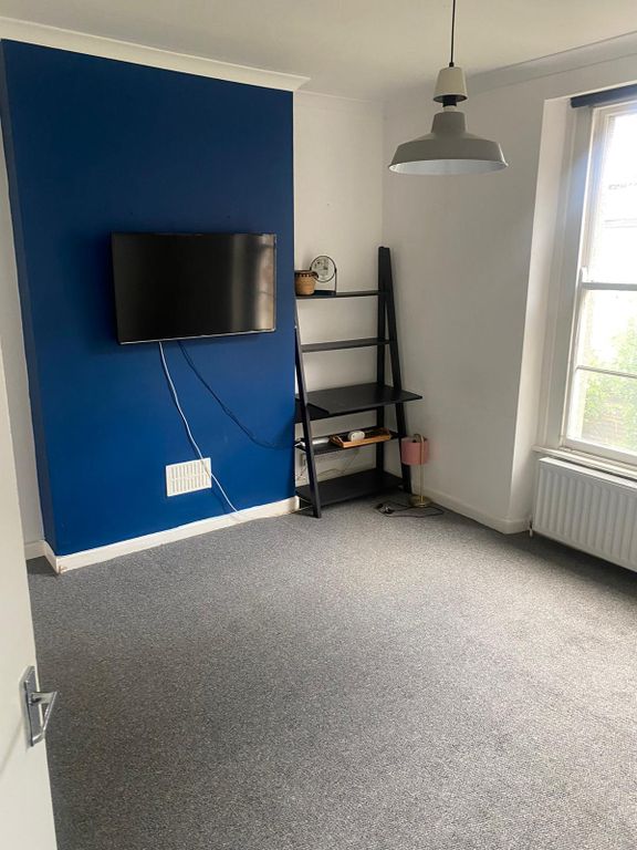 Property photo 3 of 8 Bright And Tidy Living Room Featuring A Vibrant Bl...