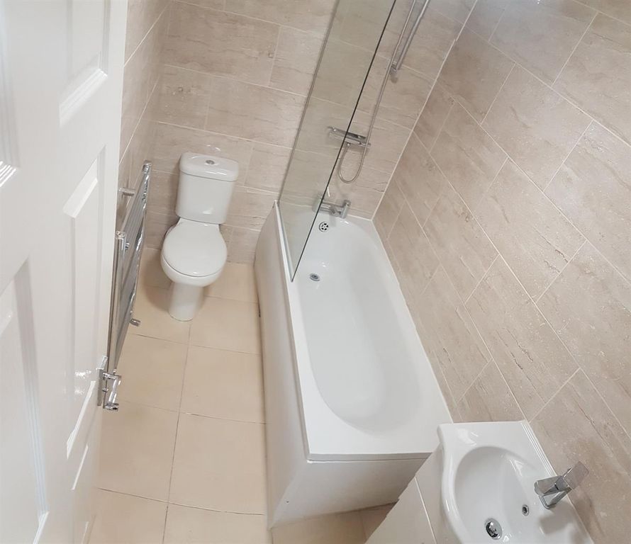 Property photo 2 of 5 Bright, Modern Bathroom Featuring A White Bath Wit...