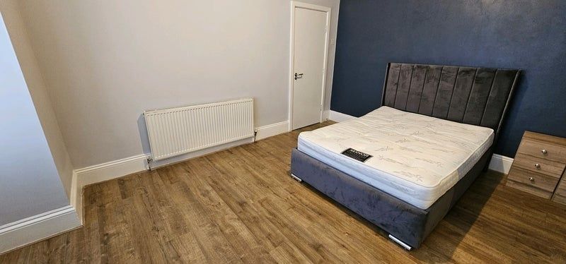 Property photo 1 of 9 A Spacious Master Bedroom Featuring A Modern Dark ...
