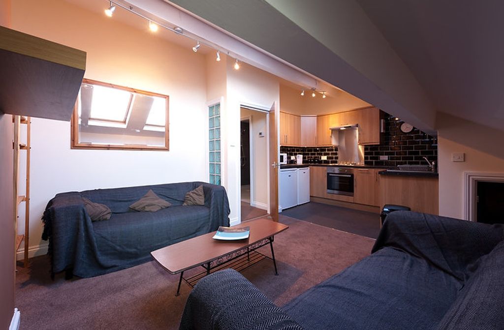 Property photo 1 of 4 A Stylish Living Room Featuring Comfortable Seatin...
