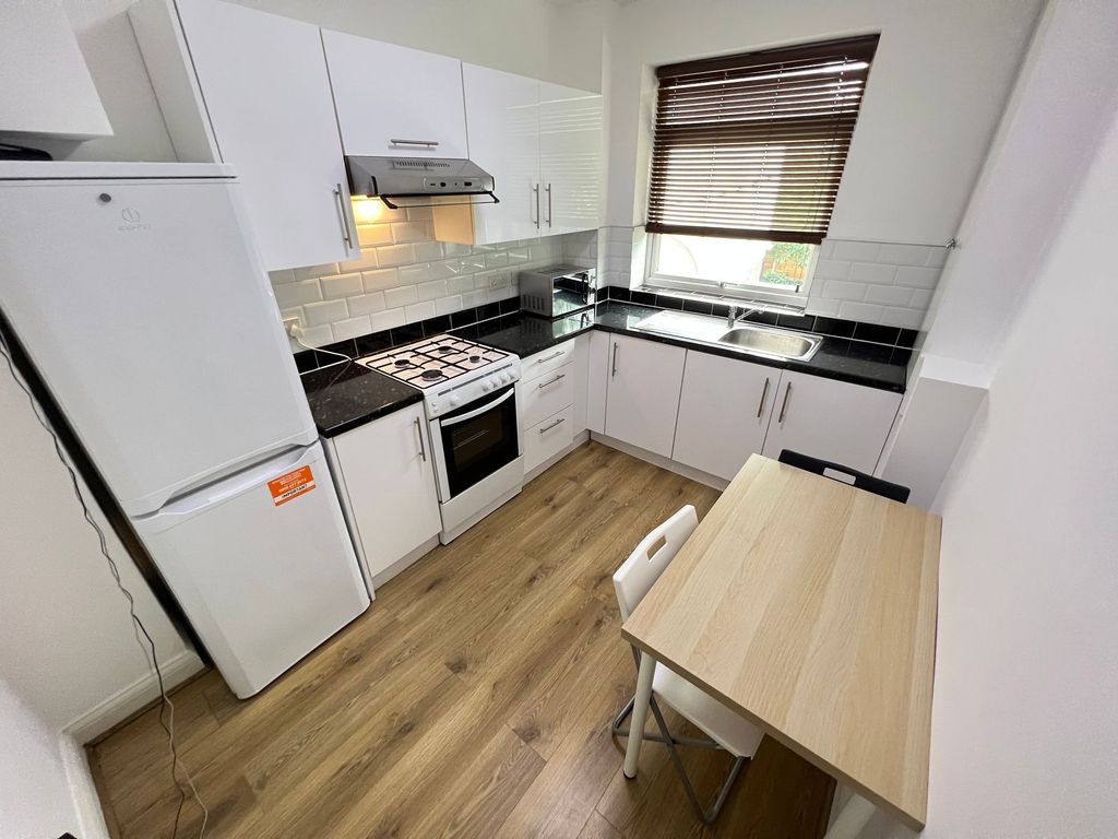 Property photo 3 of 10 A Modern And Clean Kitchen Featuring White Cabinet...