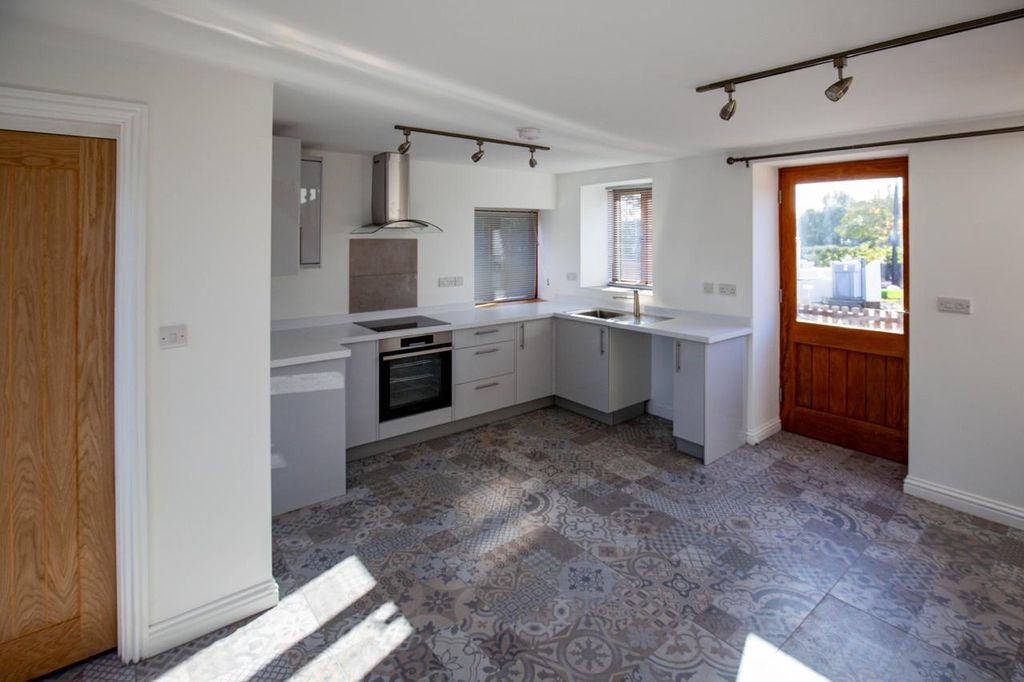 Property photo 2 of 13 Bright And Modern Kitchen Space Featuring Stylish ...