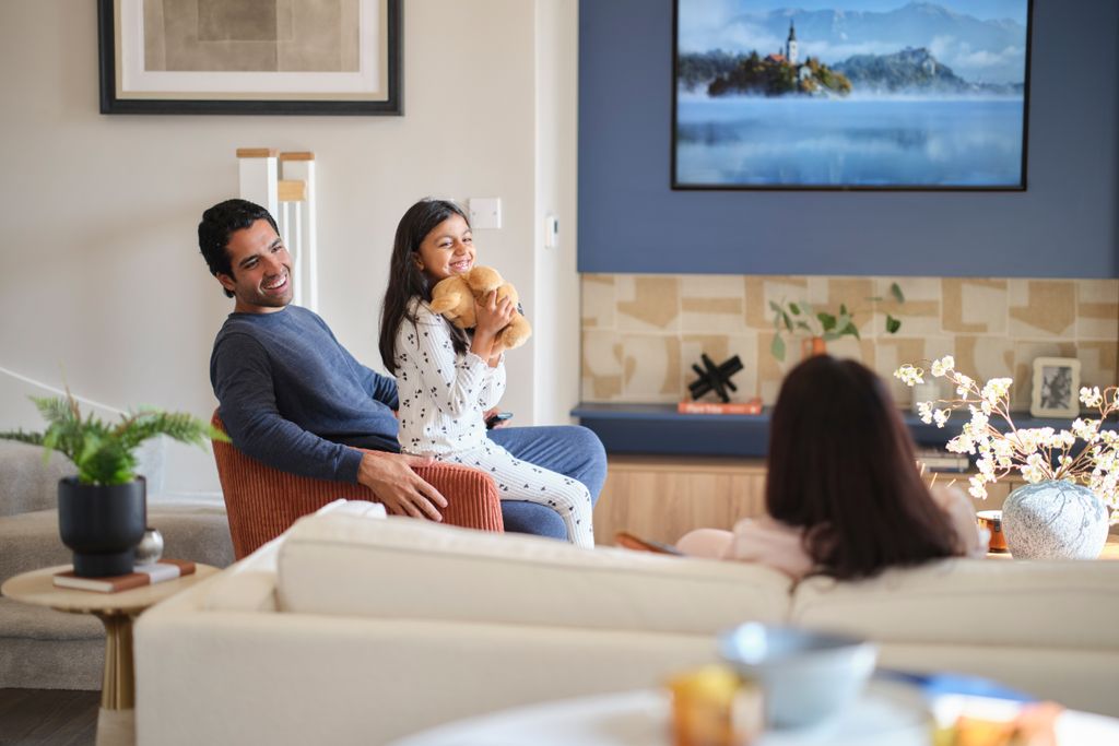 Property photo 2 of 8 Family Laughing In Living Room