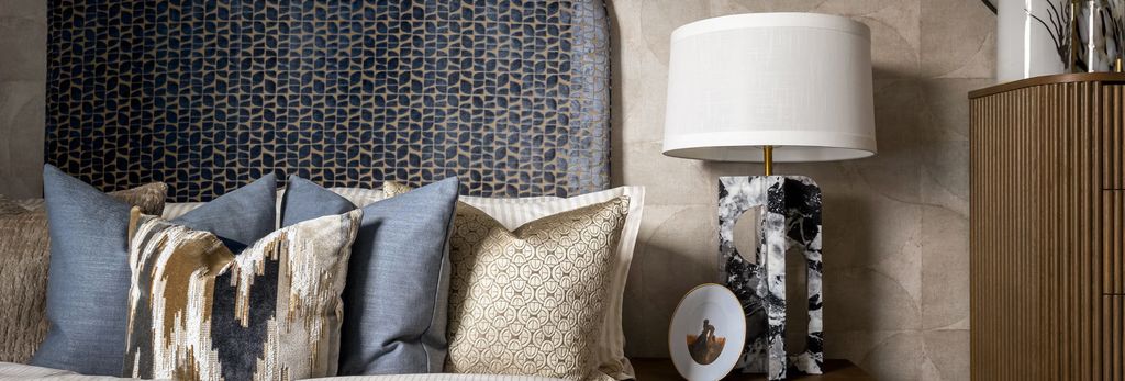 Property photo 3 of 4 Closeup View Of Bedside Decorated In Royal Blue And Beige Tones.