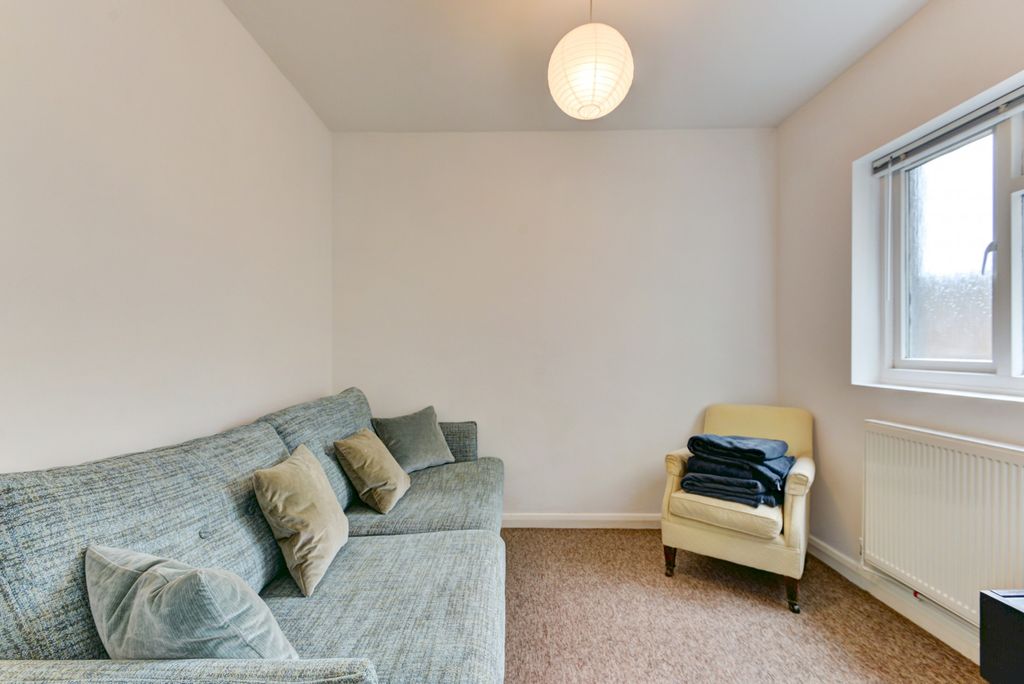 Property photo 2 of 15 A Bright And Cozy Living Room Featuring A Comforta...