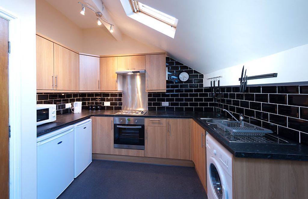 Property photo 2 of 4 Modern Kitchen Featuring Sleek Cabinetry, Ample Co...