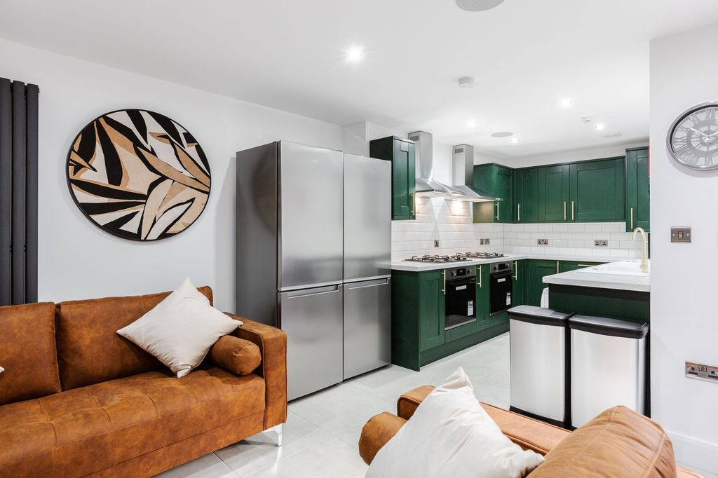 Property photo 1 of 6 Modern Kitchen With Vibrant Green Cabinets, Stainl...