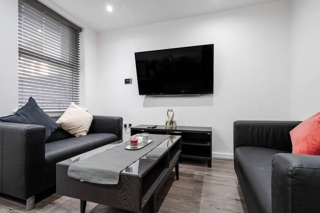 Property photo 2 of 11 Modern Living Room Featuring Two Black Leather Sof...