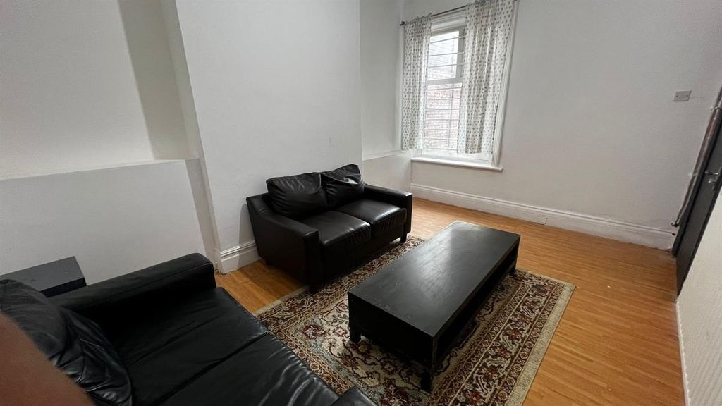Property photo 3 of 9 A Cozy Living Room Featuring Two Black Leather Sof...