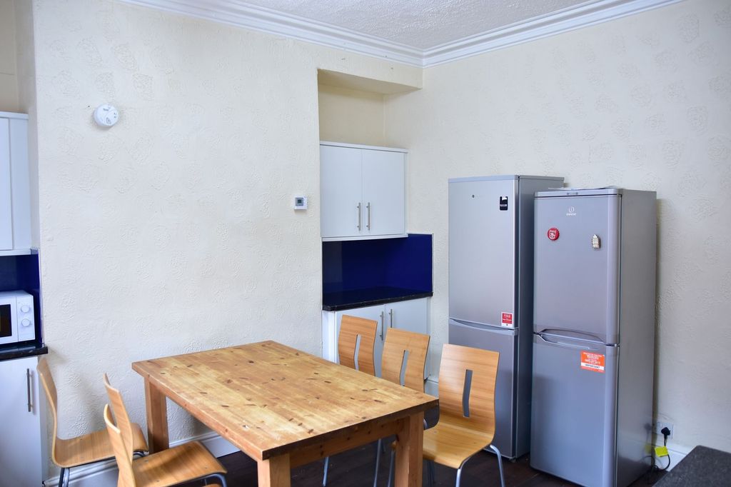 Property photo 2 of 7 A Well-Maintained Kitchen With A Wooden Dining Tab...