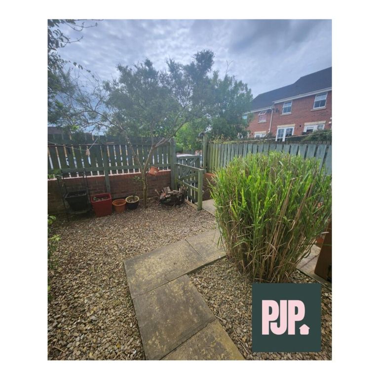 Property photo 3 of 9 A Charming Garden Space Featuring A Stone Pathway,...