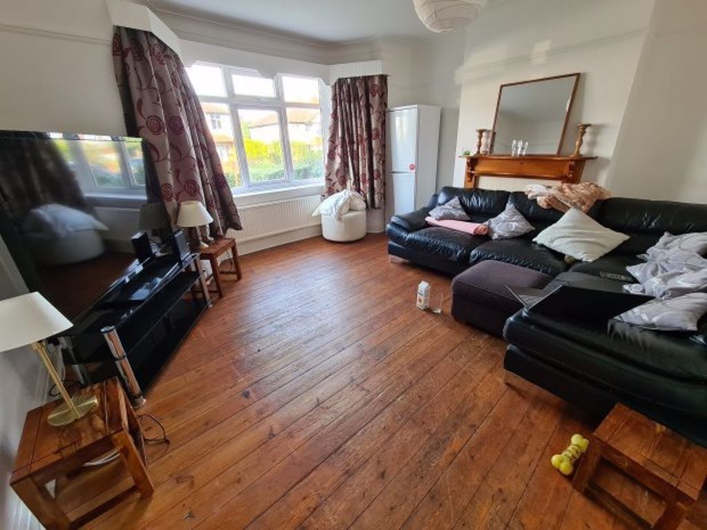 Property photo 2 of 10 A Spacious And Well-Lit Living Room Featuring Comf...