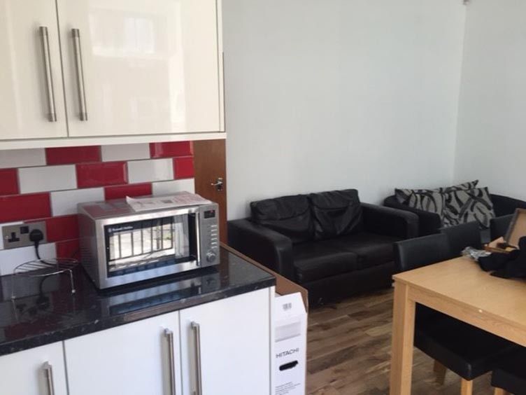 Property photo 3 of 14 A Spacious And Modern Living Room Featuring Comfor...