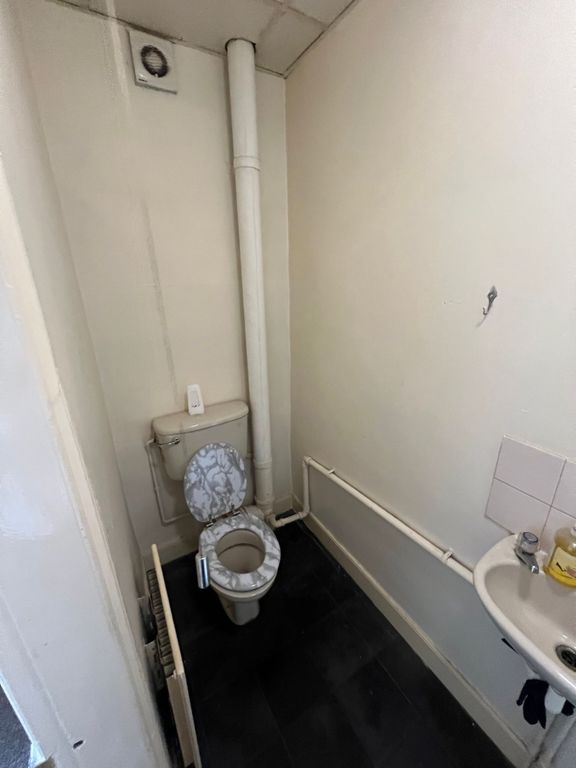 Property photo 3 of 4 Compact Toilet Room Featuring A White Toilet With ...