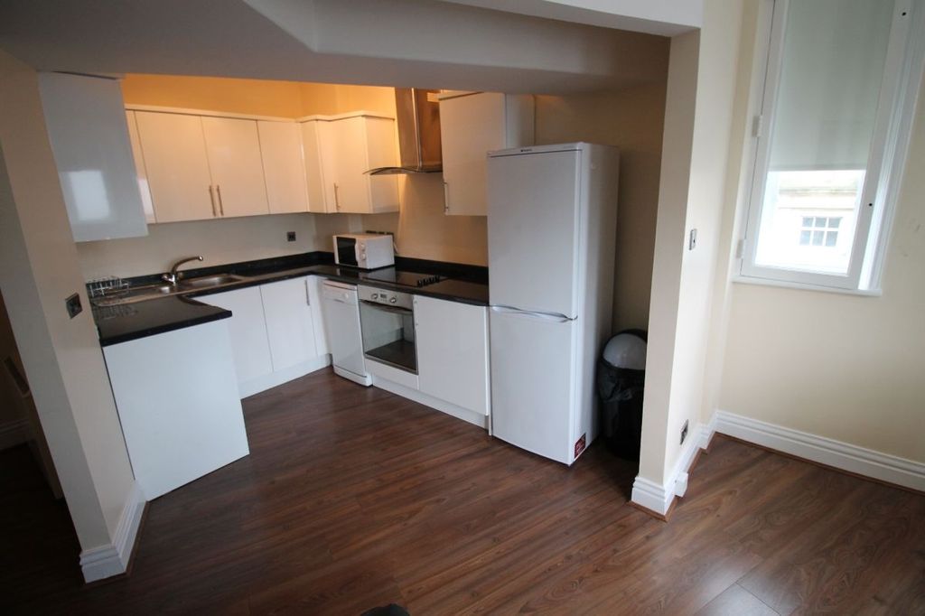Property photo 3 of 7 A Bright And Modern Kitchen Featuring White Cabine...