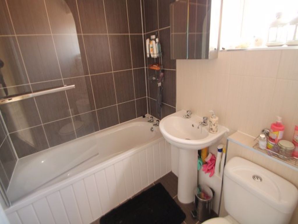 Property photo 3 of 9 Bright And Modern Bathroom Featuring A Clean White...