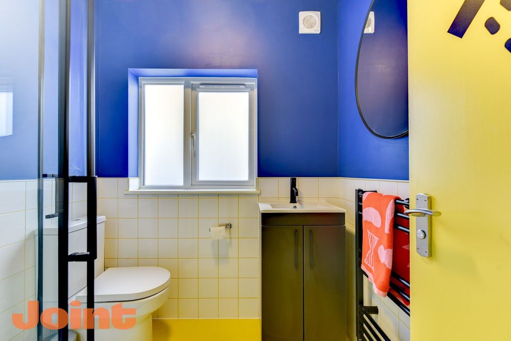 Property photo 2 of 5 Bright, Modern Bathroom With Bold Blue Walls, Fros...