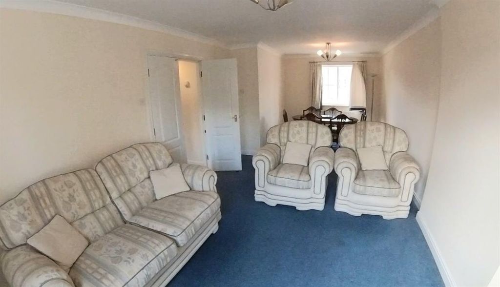 Property photo 3 of 11 A Spacious And Inviting Living Room Featuring Comf...