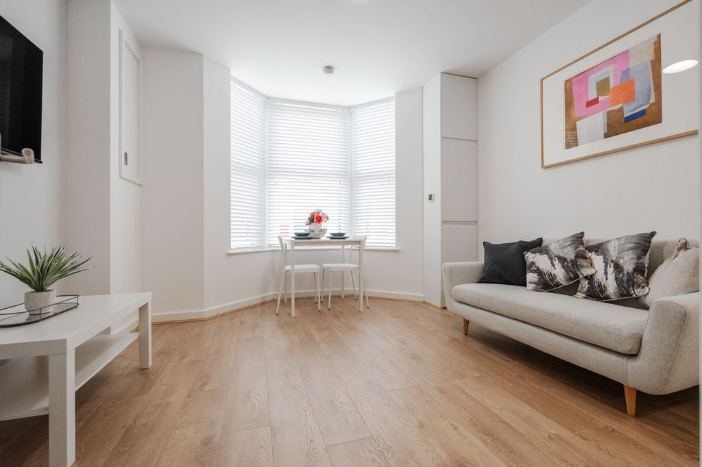 Property photo 1 of 3 Bright And Spacious Living Room Featuring Large Wi...