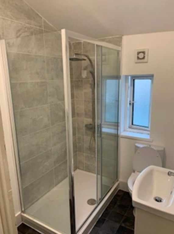 Property photo 2 of 6 A Modern Bathroom Featuring A Stylish Glass Shower...