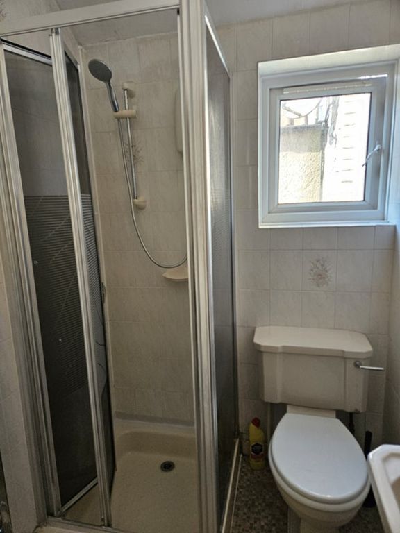 Property photo 1 of 9 A Modern Bathroom Featuring A Sleek Shower Enclosu...