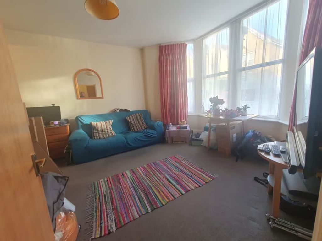 Property photo 1 of 8 Bright And Inviting Living Room Featuring Large Wi...