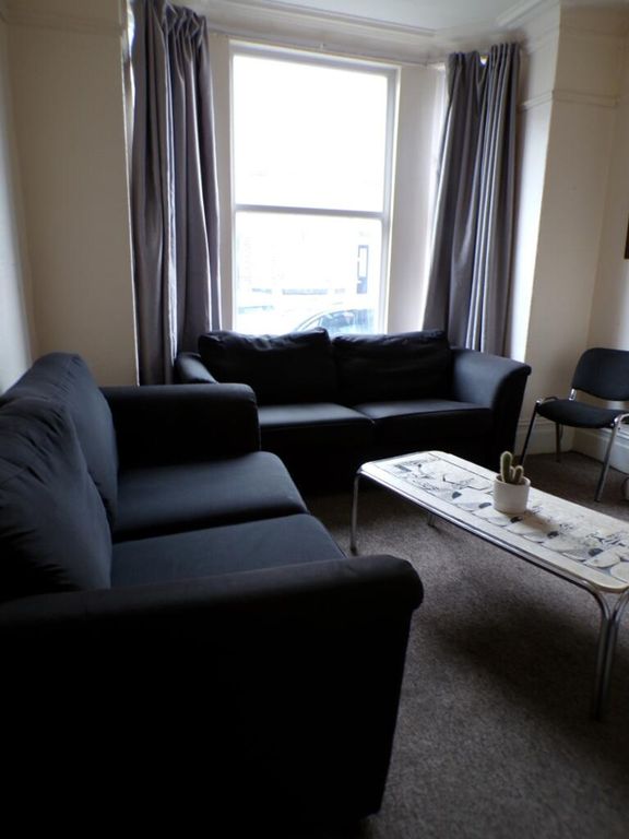 Property photo 2 of 10 A Cozy Living Room Featuring Comfortable Seating, ...