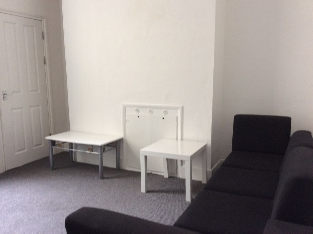 Property photo 1 of 11 A Modern Living Room Featuring A Black Sofa, A Whi...