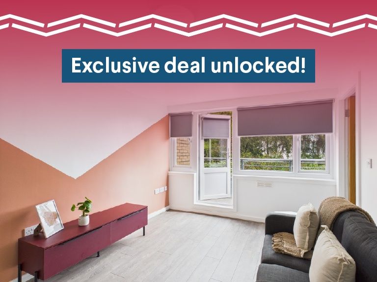 Property photo 1 of 6 Bright And Inviting Living Room Featuring Large Wi...