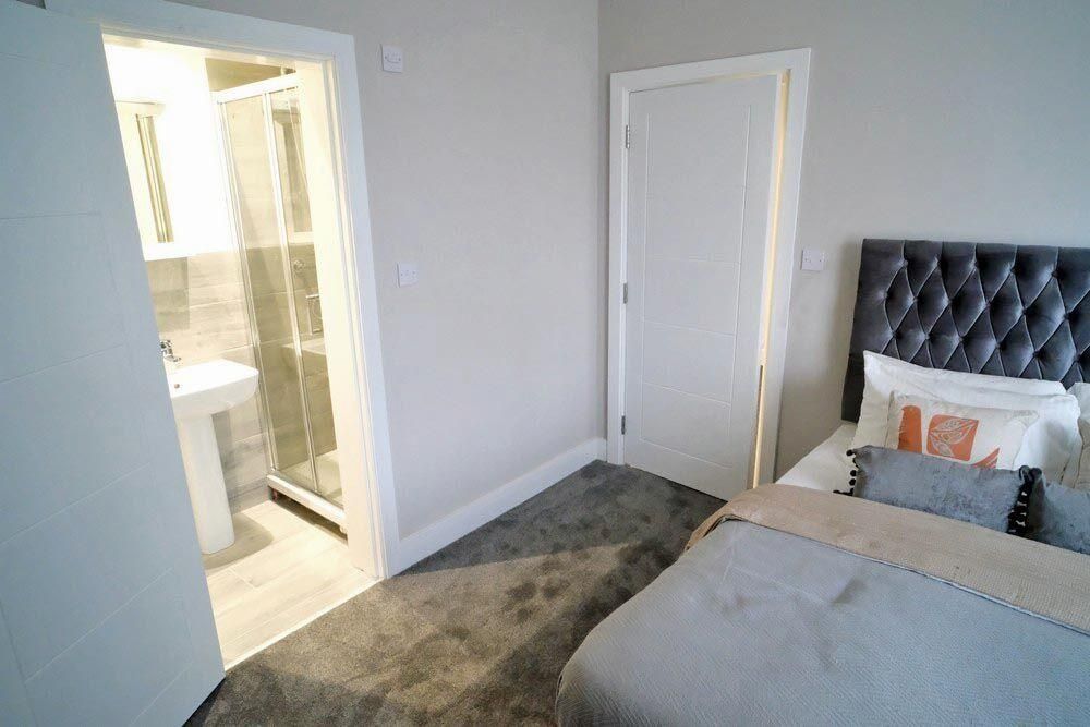 Property photo 2 of 34 A Modern And Cozy Master Bedroom Featuring A Comfo...