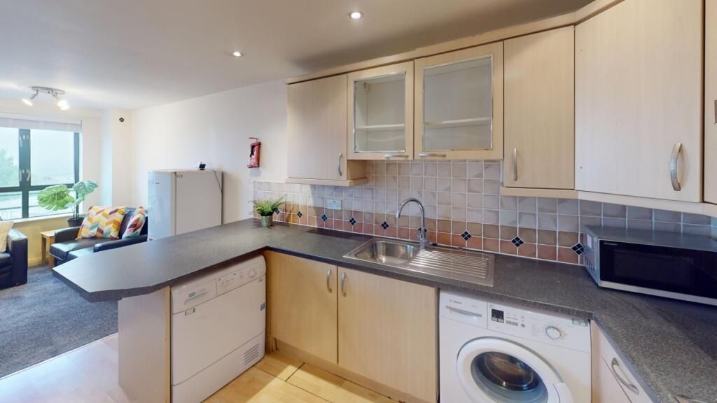 Property photo 3 of 7 Bright And Modern Kitchen Area Featuring Ample Cou...