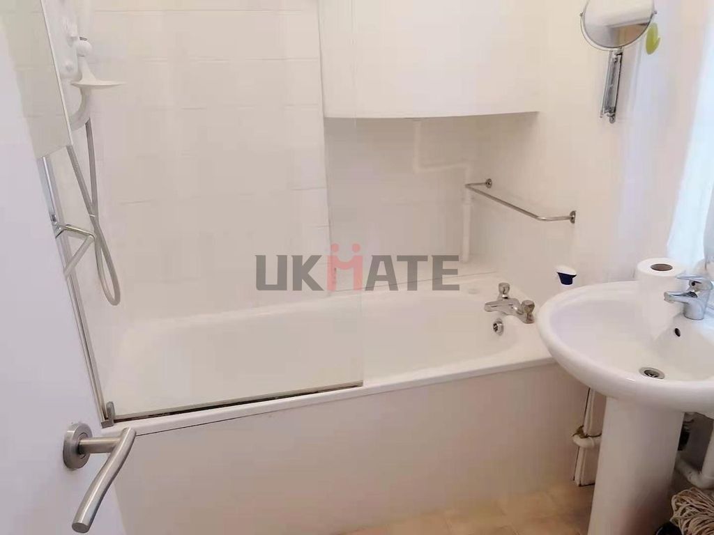 Property photo 2 of 7 Bright And Clean Bathroom Featuring A Bathtub With...