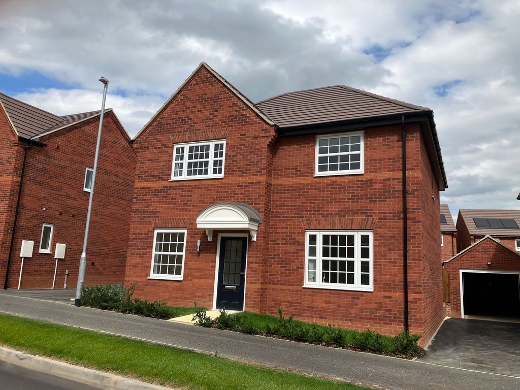 Property photo 1 of 11 A Modern Red Brick House With White-Framed Windows And A Dark Front Door Stands On A Paved Driveway