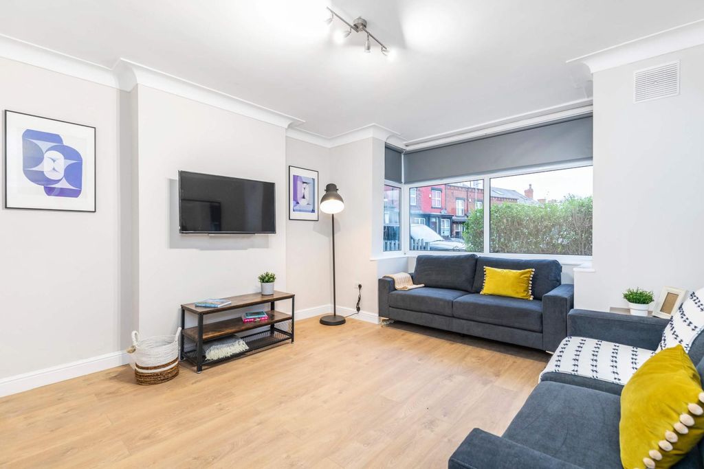 Property photo 2 of 15 A Modern, Well-Lit Living Room Featuring Comfortab...